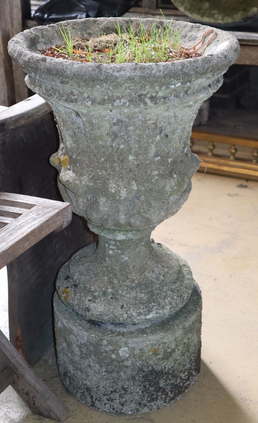 A reconstituted stone garden urn on stand, 39cm diameter, 69cm high
